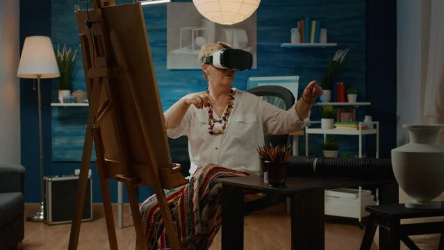 Senior artist using vr glasses with augmented reality to draw vase and create artistic masterpiece on canvas for modern hobby. 3d futuristic interactive headset used for drawing artwork design.