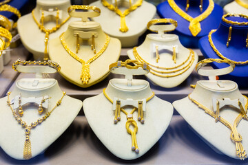 Gold jewelry on the counter of a jewelry store