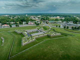 Aerial view of star shaped reconstructed 
Fort Stanwix in Rome New York with four angled wooden bastions and cannons