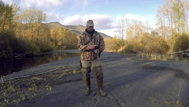 An Alaska wilderness guide demonstrates how to use a can of bear spray for self defense in the case of a grizzly bear brown bear Kodiak bear attack on Kodiak Island Alaska