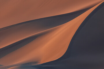 Red sand dunes in sunset in desert, Xinjiang China, beautiful lines and texture, background material