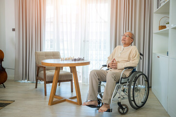 Senior man sitting on wheelchair at home,Concept loneliness and oldness.