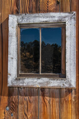 Weathered old wooden barn window in bright light