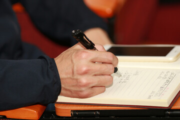 businessman writing on a paper