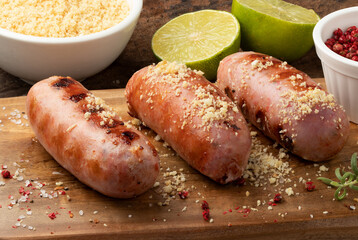 Grilled sausage with toasted manioc flour.