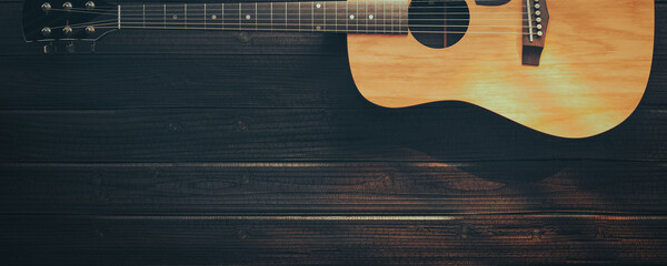 guitar on black wooden floor.