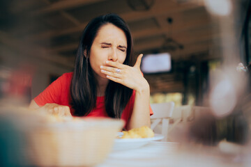 Woman Feeling Sick and Disgusted by Food Course in a Restaurant. Unhappy person having health problems after eating in a diner
 - obrazy, fototapety, plakaty
