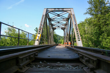 Train tracks crossing an old bridge.