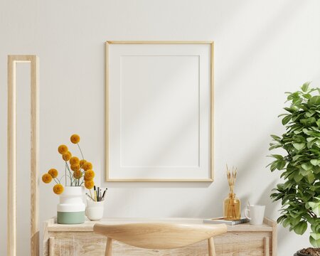 Poster mockup with vertical white frame in working room interior background.