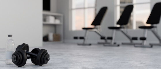 close-up, Dumbbells and copy space on the fitness gym floor over blurred gym in the background