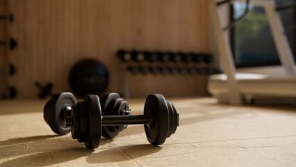 Dumbbells on the fitness floor, close-up image. Fitness gym training sport equipments concept.