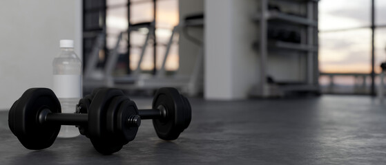 close-up, Dumbbells and a bottle of water on a black gym floor over blurred fitness background