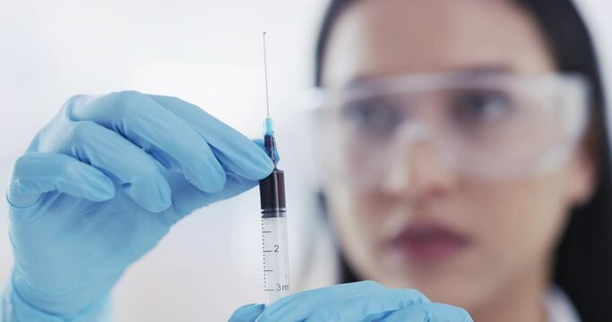 Science, research and woman hand with syringe to study blood, chemical or dna sample in lab. Scientist, girl or pathology doctor work on rna blood sample analysis for medical diagnosis in laboratory