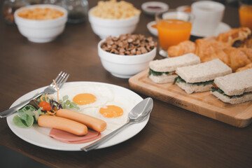 Fototapeta na wymiar Breakfast served food with beverage coffee, orange juice on table in the morning at home, Fresh and bright continental breakfast healthy