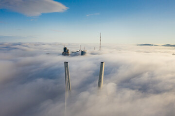 Tops of the pylons of the Golden Bridge in the dawn fog in Vladivostok