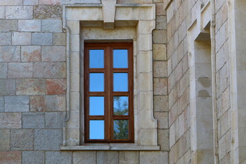 A small window on the facade of a large residential building.