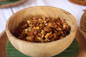 Dried fruits and nuts in bowl. Morning breakfast in a wood bowl. Good times and holidays in Bali. Healthy Breakfast.