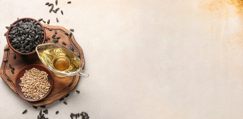 Sunflower oil and seeds on light background with space for text, top view