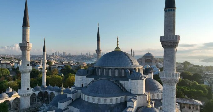 Istanbul, Turkey. Sultanahmet area with the Blue Mosque and the Hagia Sophia with a Golden Horn and Bosphorus bridge in the background at sunrise.