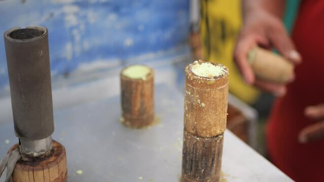 Process of making traditional indonesian food stall, kue putu bambu. From rice flour and formed using bamboo molds. the whistle sound of cooking and pandan aroma is very si