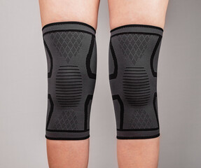 Woman legs in knee pads to relieve pain or discomfort, to prevent muscle, ligament strain,...