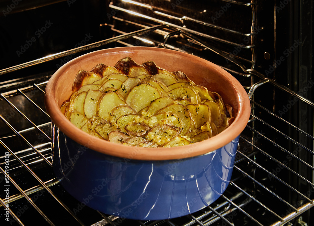 Sticker Potato gratin in a ceramic form in the form of flower after baking in the oven