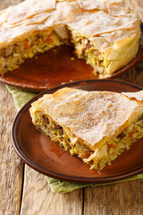 Homemade traditional moroccan pastilla or chicken bastilla. Halal food. closeup in the plate on the table. Vertical