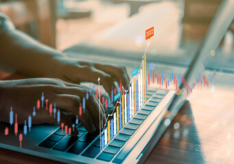 Business analytics and financial concept, Plans to increase business growth and an increase in the indicators of positive growth in 2022 floating above digital laptop computer.