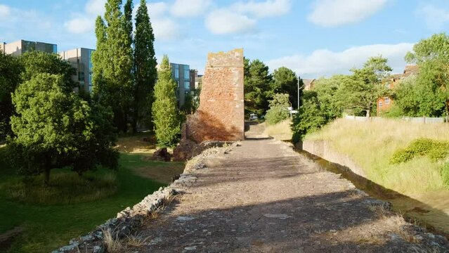 Walking the Old Exe Bridge, a ruined medieval arch bridge in Exeter, Devon, England, UK, dating back to 1214
