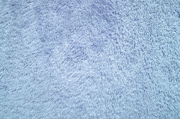 Pastel blue towel texture background. Fluffy pile fabric backdrop.