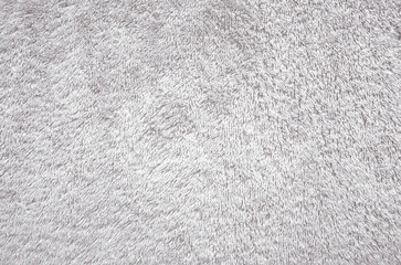 Light gray towel texture background. Fluffy pile fabric backdrop.