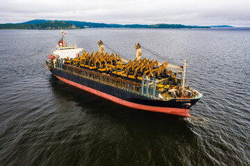 Shipment of excavators and other equipment on the deck of a cargo ship