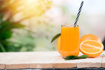 glass of fresh orange juice with fresh fruits on wooden table, high Vitamin C, orange drink, nature background