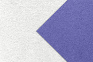 Texture of white paper background, half two colors with very peri arrow, macro. Structure of craft violet cardboard.
