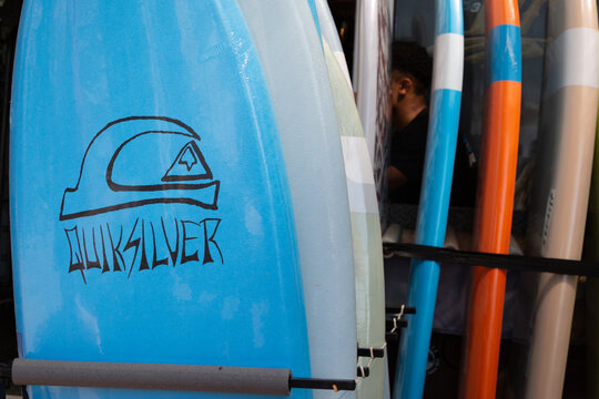 quiksilver logo sign and brand text on surf board store facade clothing shop entrance
