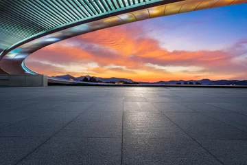 Foto op Canvas Empty square floor and bridge with sky cloud background at sunset © ABCDstock