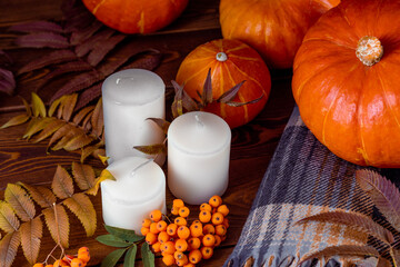 Composition of pumpkins and autumn leaves on wooden background. Halloween, autumn, tradition and...