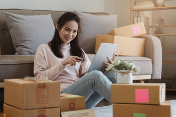 Asian SME business woman working at home office. online shopping concept