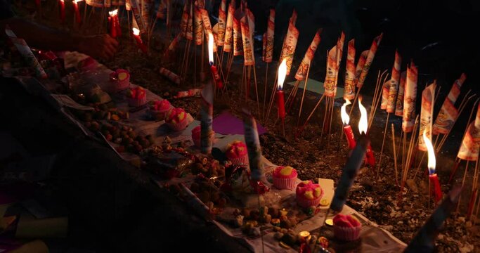 Chinese hungry ghost festival burning flame fire glowing ashes firefly colourful variety prayer paper joss money fake currency joss stick mini fag food fruit