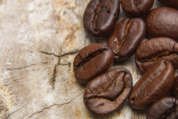 Coffee beans fall on rustic wooden table  Delicious luxury coffee beans and the aroma of morning coffee.