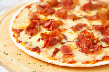 Freshly cooked cheesy bacon pizza