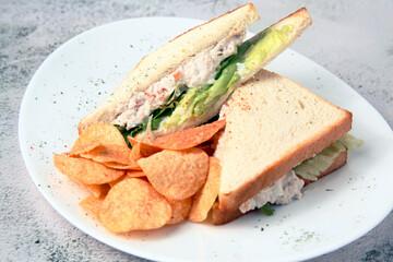 Freshly made chicken sandwich served with potato chips