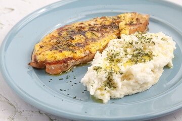 Freshly prepared baked salmon served with mashed potato