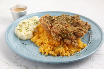 Freshly cooked fried chicken served with rice and mashed potato