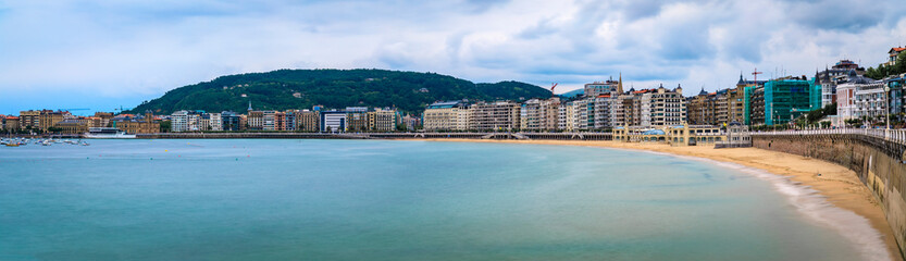 Panorama of La Concha bay, beach and waterfront hotels in San Sebastian, Spain