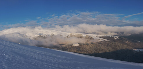 Mountain range covered with snow. Winter landscape. Panorama from several shots.