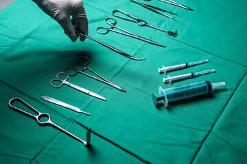 Shot of modern medical supplies and tools and hands of doctor dressed in white rubber gloves.
