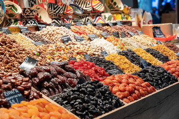 Market counter with various assorted dried fruits and nuts. Healthy food. Local market place.