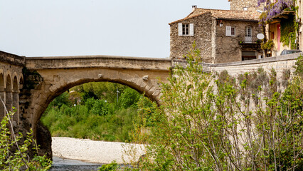 Fototapeta na wymiar View of the old bridge of Vaison la Romaine village in Provence, France