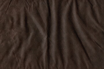 The texture of coarse crumpled fabric. The background of the crumpled fabric is brown.